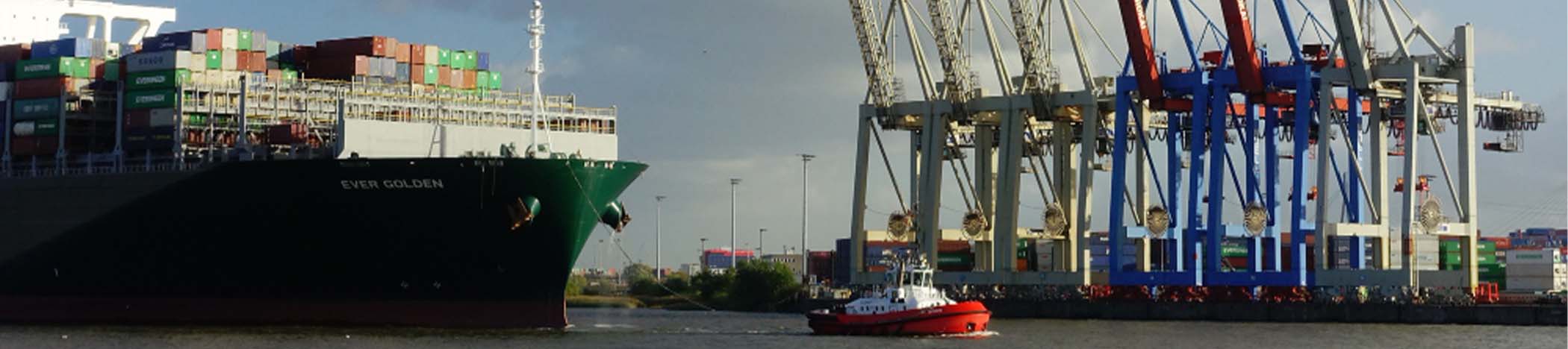 A panoramic view of cargo containers and a container ship at an Atlantic Canadian port, with a subtle overlay of financial charts, global trade routes, and a world map, symbolizing the financial risks behind international expansion.